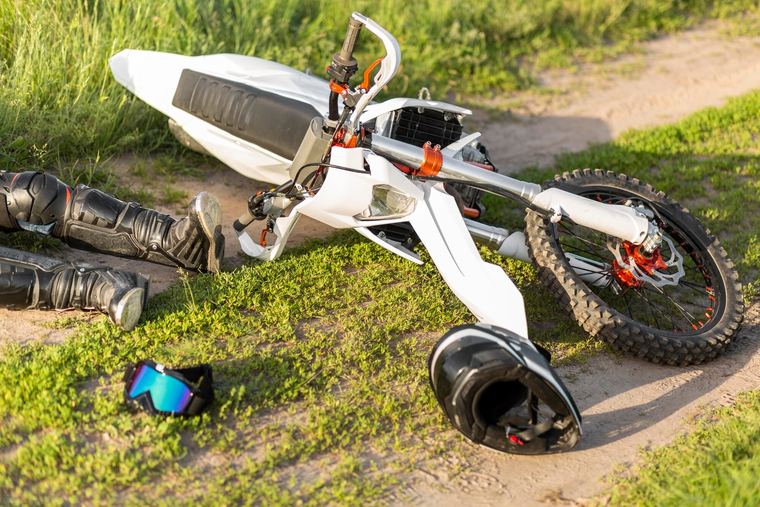 A downed two-wheeled rider after a roadway crash